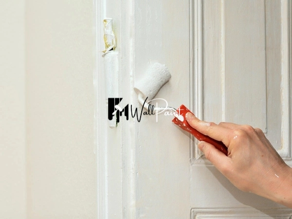 A vibrant blue door painting with white floral designs.