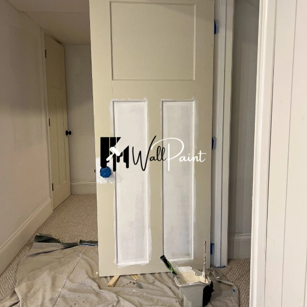 Home renovation project_ door painting with a light green hue, showcasing the details of the panel door and the painting process.