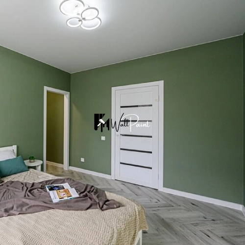 A wall painting Dubai project involving a green wall, with visible paint and tools, suggesting a residential or commercial interior painting service.
