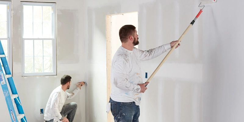 Two painters working, offering wall paint services in Dubai.